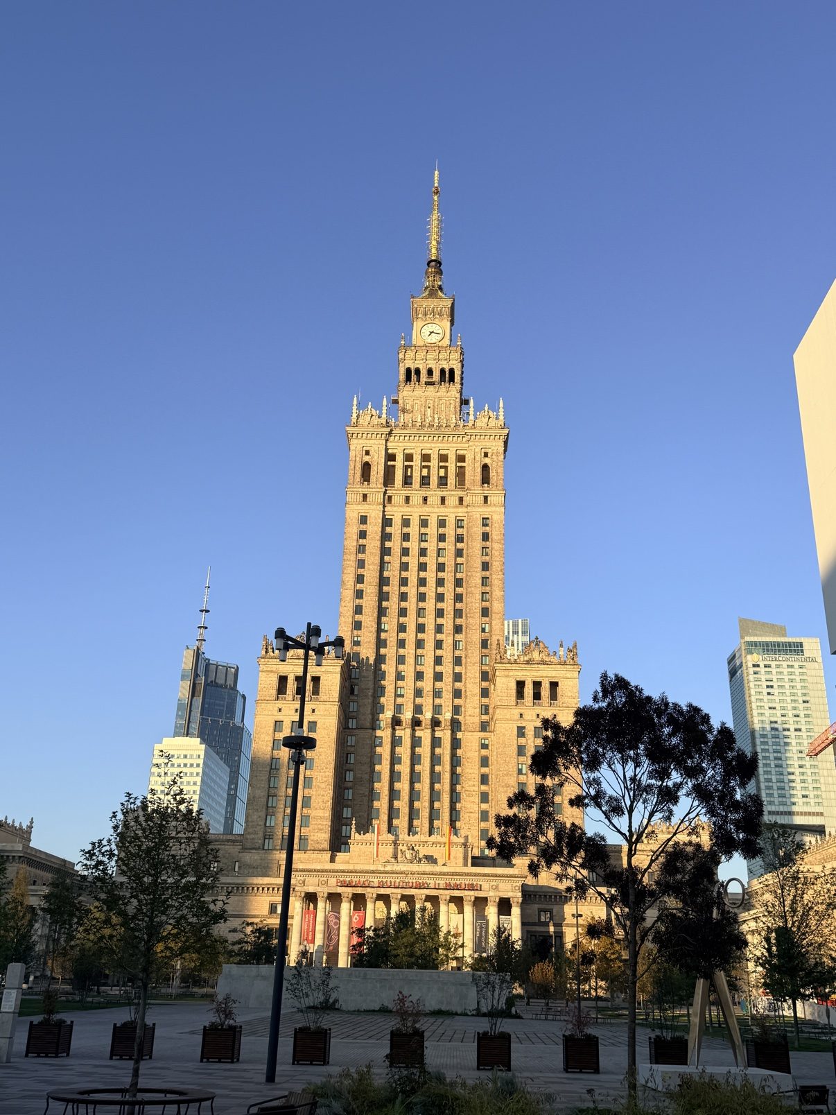 Full frontal view of Warsaw’s Palace of Culture and Science in golden light