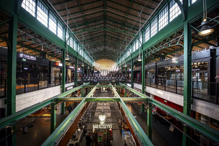 Steel-framed interior of Warsaw’s restored Hala Koszyki market hall