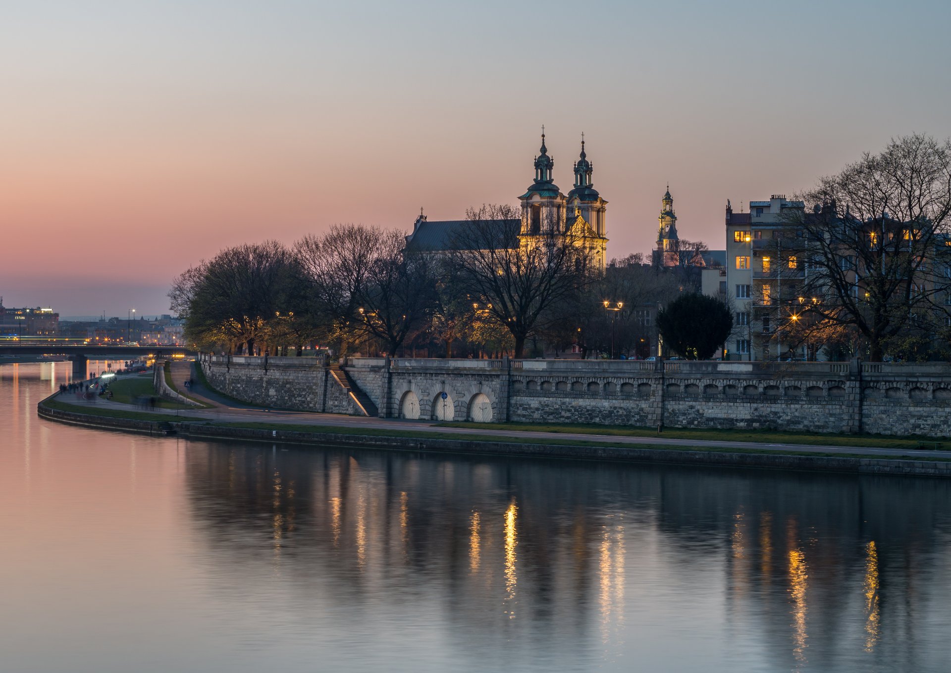 Vistula riverbank with Skałka church in Kraków at dusk